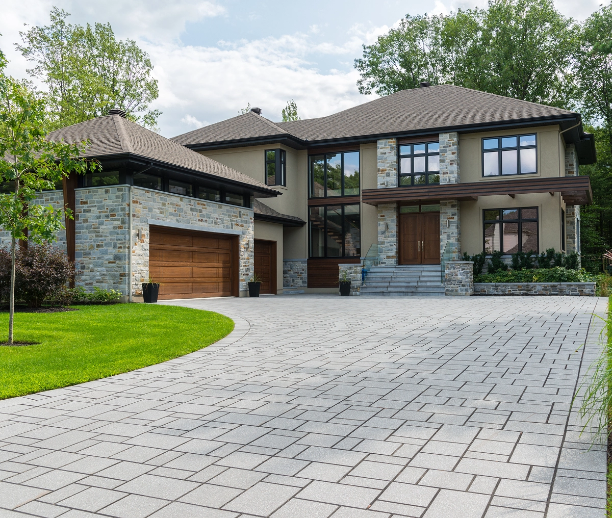 Modern house with large driveway and garden.